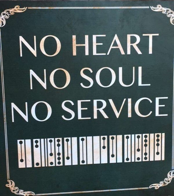 A sign reading "NO HEART NO SOUL NO SERVICE" in English and Clickwise